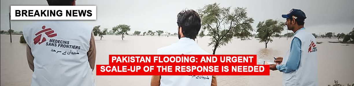An MSF staff members looking to a flooding area