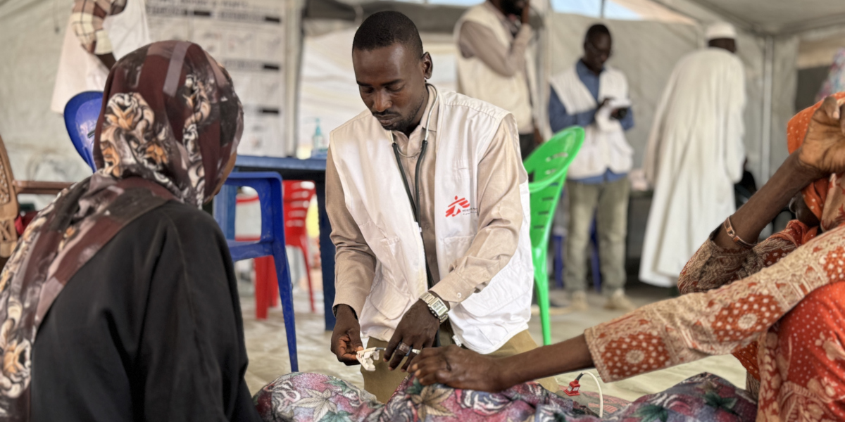 Two surgeons wearing masks and gown perform surgery in an operating theatre in Rutshuru general reference hospital in Democratic Republic of Congo.