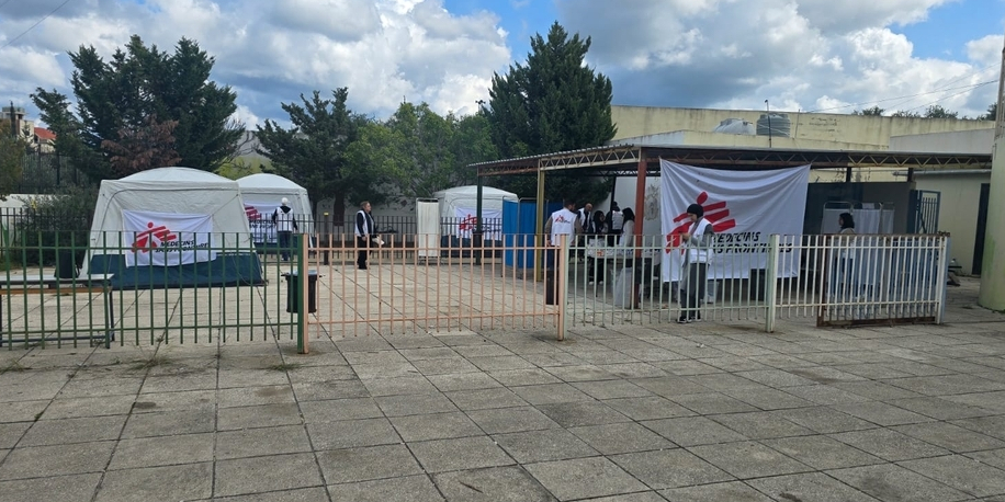 Two surgeons wearing masks and gown perform surgery in an operating theatre in Rutshuru general reference hospital in Democratic Republic of Congo.